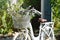 Vintage white bicycle with bouquet of flowers in basket.