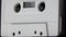 Vintage White Cassette Tape Playing Up Close Shown at an Angle