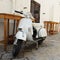 Vintage white italian scooter on the street in downtown city Gallipoli, Salento Puglia in South Italy