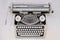 Vintage white typewriter on white background.