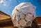 Vintage white umbrella against blue sky.