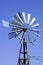 Vintage wind turbine small windmill by blue sky