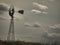 Vintage Windmill Silhouetted in Cloudy Sky