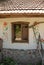 Vintage window with  wooden frame and open shutters. Old house in village Reflection in window