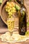 Vintage wine glass against background bunch of grapes and cooper