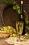 Vintage wine glass against background cluster of grapes and wine