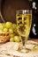 Vintage wine glass against background cluster of grapes and wine