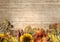 Vintage wooden background with autumn leaves, pumpkins, sunflowers, rowan. The border of the autumn harvest