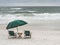 Vintage Wooden Beach Chairs on Stormy Beach