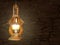 Vintage wooden burning lamp hanging on an ancient stone wall background