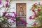 Vintage wooden door framed by climbing flowers/bougainvillea trellis plant growing on the facade of a house