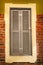 Vintage wooden European window. Vintage window with gray painted blinds