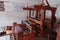 Vintage wooden mechanical cloth making workplace with loom.