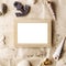 Vintage wooden photo frame on craft paper with sand and sea shells mock up