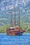 Vintage wooden pirate schooner in the open ocean against the background of the sea horizon. Tourist cruises in the Mediterranean