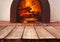 Vintage wooden planks over blurred traditional stove for baking pizza