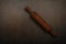 Vintage wooden rolling pin for dough on table