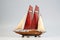 vintage wooden sailboat racing with full sails