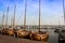 Vintage wooden sailboats docked in a Holland harbor