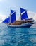 Vintage Wooden Ship with Blue Sails