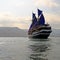 Vintage Wooden Ship with Blue Sails