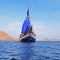 Vintage Wooden Ship with Blue Sails