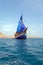 Vintage Wooden Ship with Blue Sails