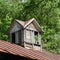 Vintage wooden shuttered cupola on barn roof