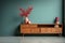 Vintage wooden sideboard on blue Turquoise wall