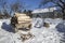 Vintage wooden sledge with firewood stands on a snow-covered pa