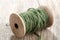 Vintage wooden spool with green sisal