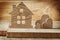 Vintage wooden toys house and three hearts on wood background
