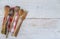 Vintage wooden utensil and checkered napkin on rustic white paint wooden background