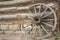 Vintage wooden wagon wheel weeds western log stone wall