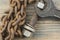 vintage wrench wood board with iron chain link. Rusted chain hanging in front of a wood background. Industrial detailed object.