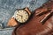 Vintage wristwatch with luxury italian leather strap and brown trendy oxford shoes.