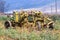 Vintage Yellow Farm Implement Against Rural Farm Landscape