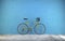 Vintage yellow sports bike stands on a background of blue brick wall, 3D rendering