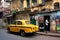 Vintage yellow taxi car stopped at the old street