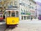 Vintage yellow tram in the city center on the sunny spring day, Praca da Figueira, Lisbon, Portuga