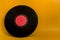 Vinyl black plate with red center on yellow background