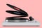 Vinyl record player or DJ turntable with flying vinyl plate on pink background.