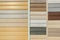 Vinyl siding with imitation wood texture in bright palette of colors. Plastic wall covering for exterior decoration of house.