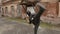 Violent bandit training with baseball bat making kick to camera