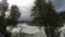 Violent rapid river waterfall during flood in late summer with dense forest