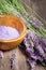 Violet bath salt with fresh lavender on wooden background