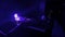 violet blue light in the darkness standing on electronic piano keayboard with female hands playing music. Romantic