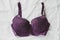 Violet bra on the bed. Women tender lingerie, underwear.