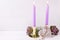 Violet color burning candles, decorative heart and succulents e