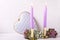 Violet color burning candles, decorative heart and succulents e